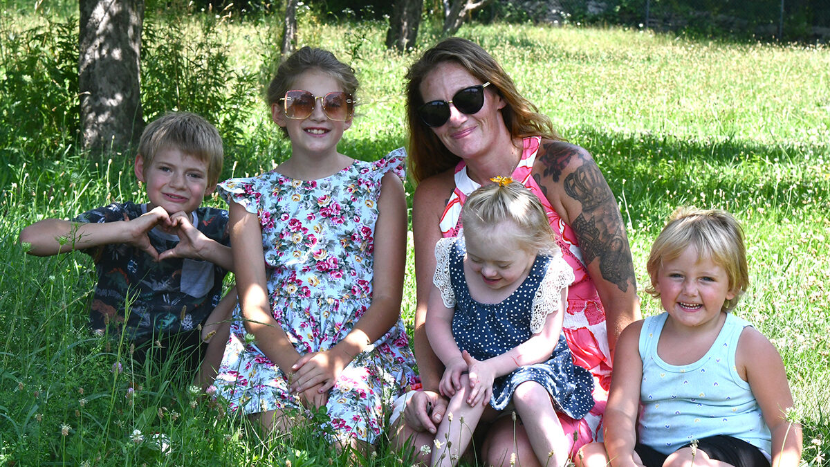 Shannon Sharkazy and her children, from left, Carter, 10; Blake, 11; Mason, 5; and Emerson, 4 spend time in the orchard on their Beach Lake property.